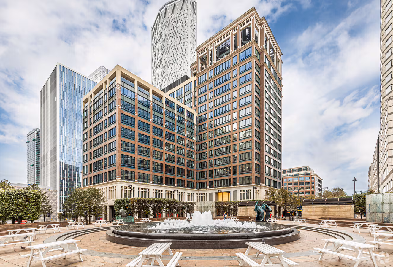 Exterior of The Cabot tower at Cabot Square with fountain in Canary Wharf, London