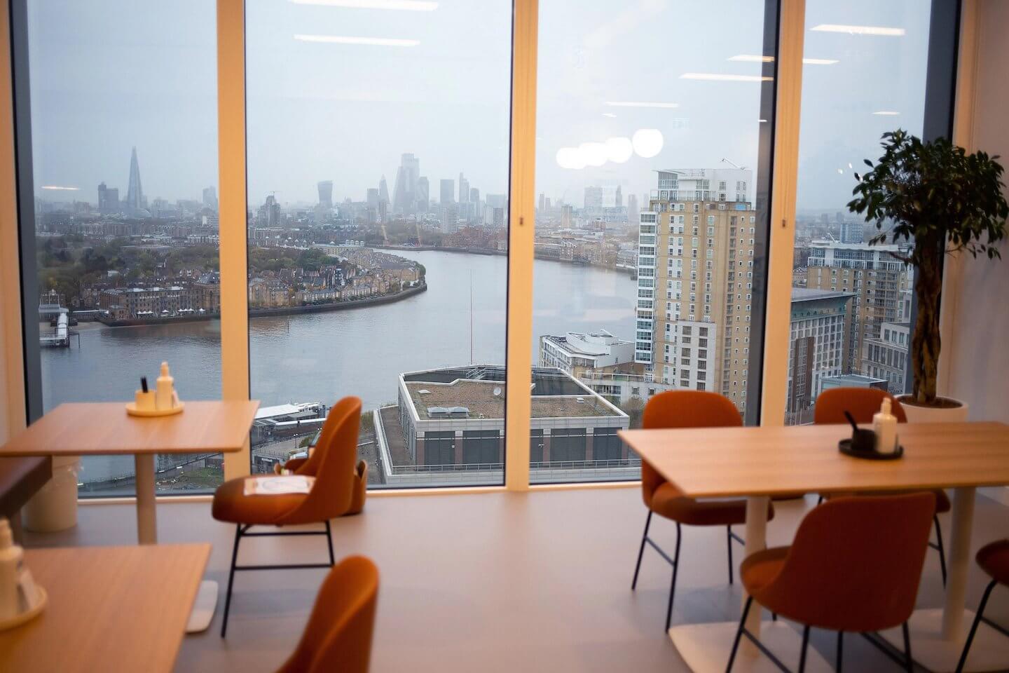 Premium co-working lounge with seating and city views inside The Cabot, Canary Wharf